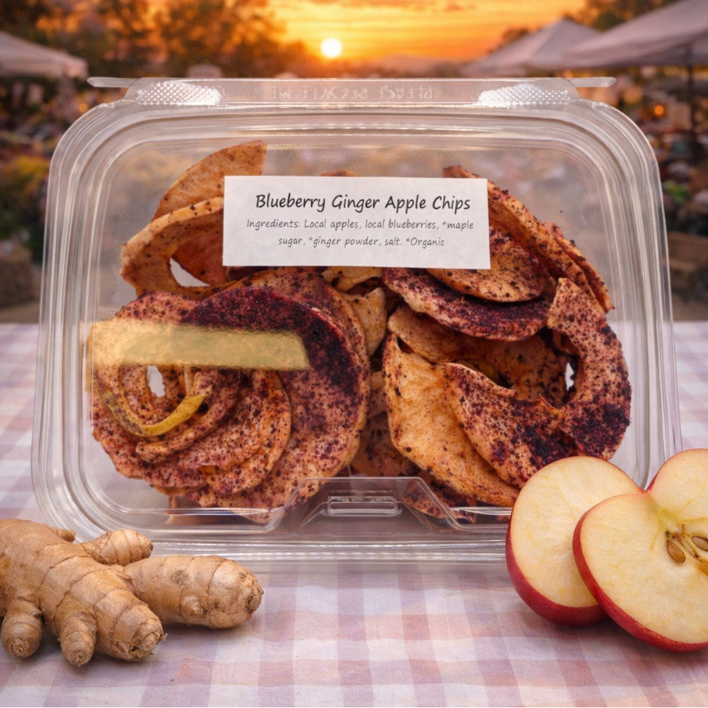 Packaged apple chips with a 'Farmers Market' sign and sunset background